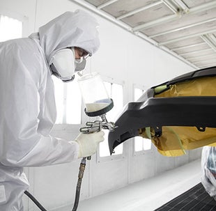 Collision Center Technician Painting a Vehicle | Classic Toyota in Waukegan IL